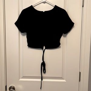 Black crop top with strings that tie around your waist.